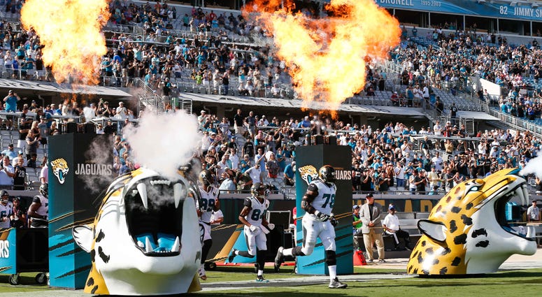 Jacksonville Jaguars players enter the field before a football game Jacksonville Jaguars players enter the field before a football game