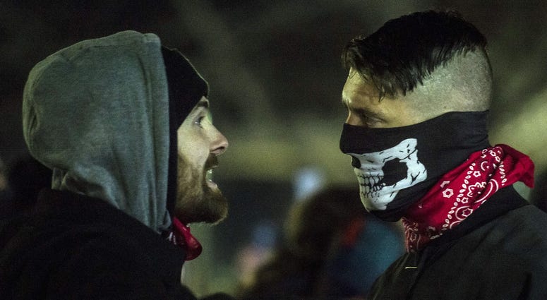Feb 2, 2018; Fort Collins, CO, USA; A protestors of Charlie Kirk, a speaker for national conservative group Turning Point USA, left, and a white supremacist counter-protestor argue at the Lory Student Center on campus at Colorado State University.