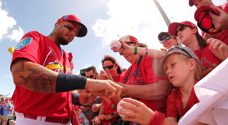 St. Louis Cardinals catcher Yadier Molina (4) signs autographs for fans before the game against the Houston Astros at Roger Dean Stadium. St. Louis Cardinals catcher Yadier Molina (4) signs autographs for fans before the game against the Houston Astros at Roger Dean Stadium.