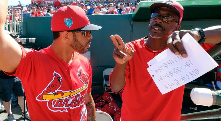 St. Louis Cardinals left fielder Tommy Pham (28) listens to St. Louis Cardinals assistant coach Willie McGee St. Louis Cardinals left fielder Tommy Pham (28) listens to St. Louis Cardinals assistant coach Willie McGee