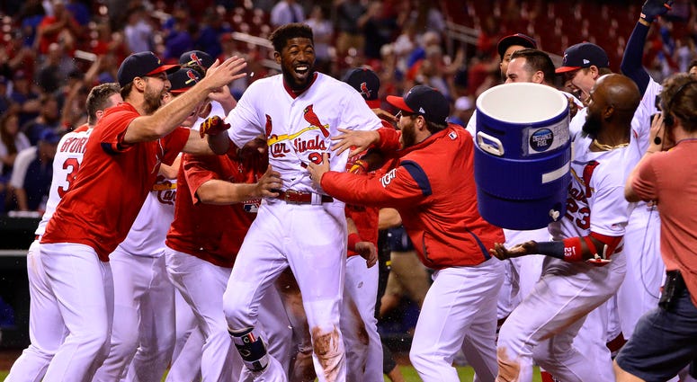 St. Louis Cardinals right fielder Dexter Fowler (25) celebrates with teammates after hitting a walk off two run home run St. Louis Cardinals right fielder Dexter Fowler (25) celebrates with teammates after hitting a walk off two run home run