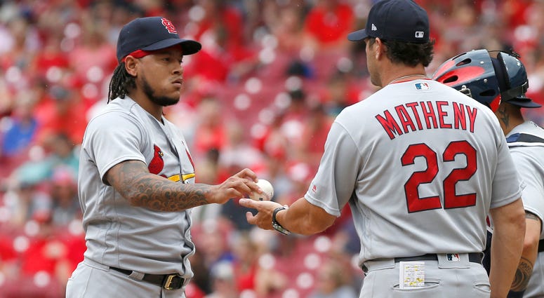 St. Louis Cardinals manager Mike Matheny (22) takes the ball from starting pitcher Carlos Martinez St. Louis Cardinals manager Mike Matheny (22) takes the ball from starting pitcher Carlos Martinez