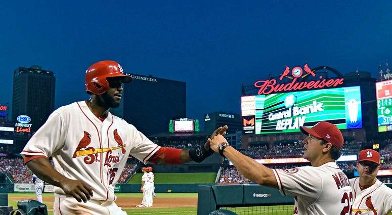 St. Louis Cardinals right fielder Dexter Fowler (25) is congratulated by manager Mike Matheny St. Louis Cardinals right fielder Dexter Fowler (25) is congratulated by manager Mike Matheny