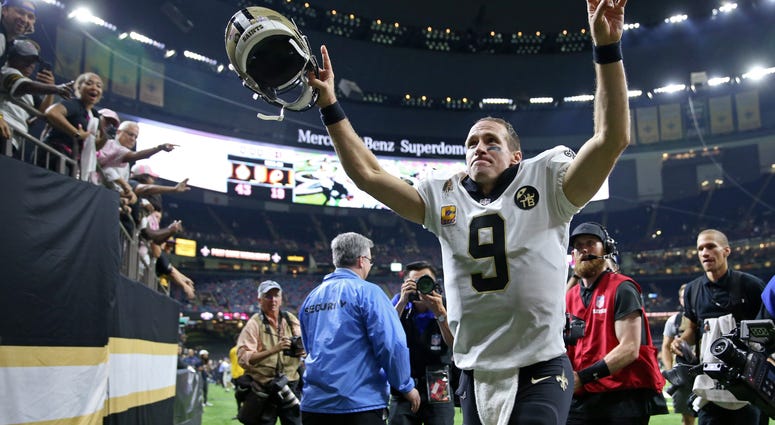 New Orleans Saints quarterback Drew Brees (9) runs off the field New Orleans Saints quarterback Drew Brees (9) runs off the field