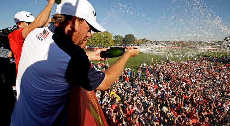 J.B. Holmes of the United States sprays champagne after winning the Ryder Cup during the single matches in 41st Ryder Cup at Hazeltine National Golf Club. J.B. Holmes of the United States sprays champagne after winning the Ryder Cup during the single matches in 41st Ryder Cup at Hazeltine National Golf Club.