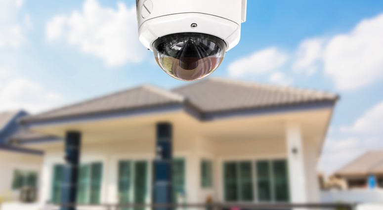 A house with a security camera outside. A house with a security camera outside.