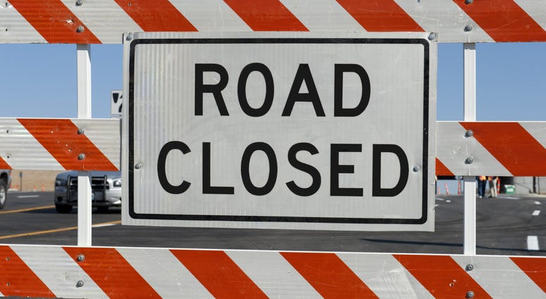 road closed Worn Road Closed Sign in front of street being repaired