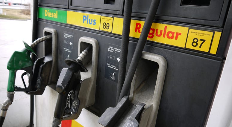 Close-up of gas pump nozzles at a gas station.
