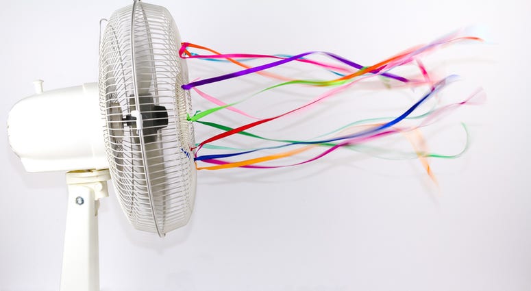 fan An electric fan blowing colorful silk ribbons