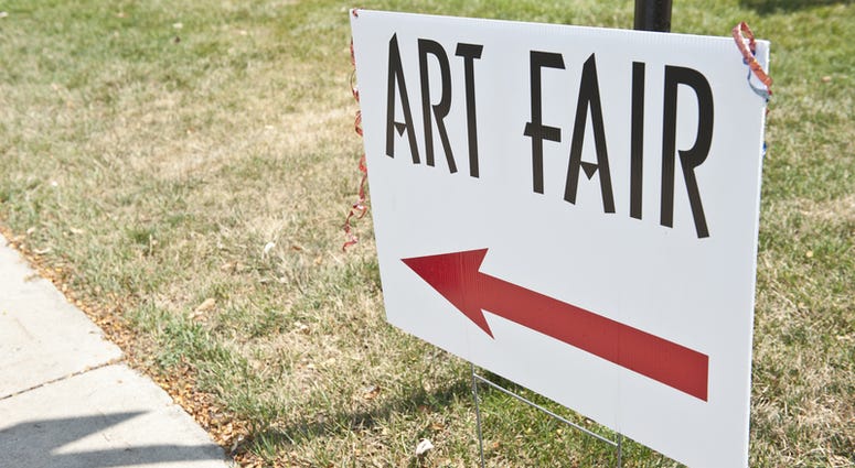 art fair A sign that says ART FAIR with a red arrow pointing left.