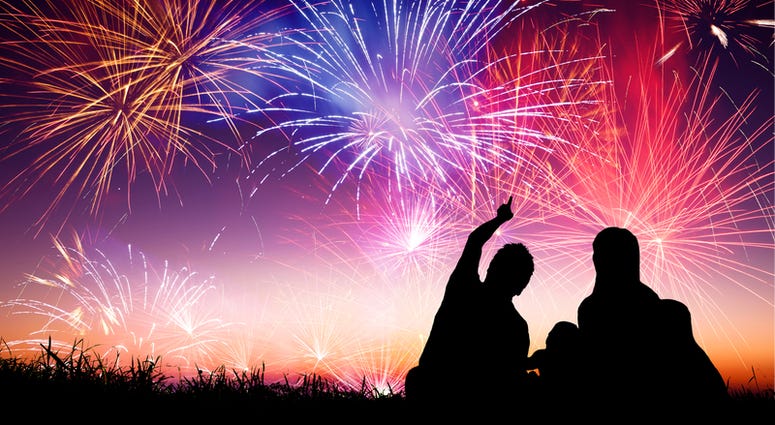 Happy family sitting on floor and watching the fireworks