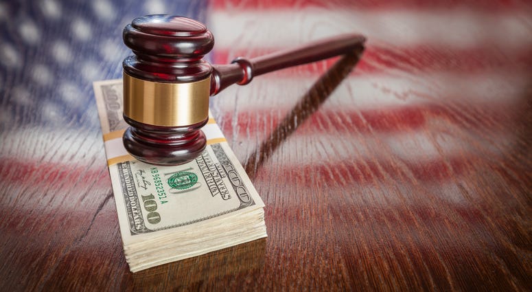 Gavel on top of money