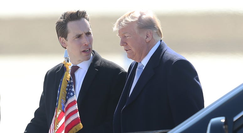 U.S. Senate hopeful, Missouri Attorney General, Josh Hawley talks with U.S. President Donald Trump after the President's arrival at St. Louis-Lambert International Airport in St. Louis on March 14, 2018. Trump is in St. Louis for a roundtable meeting with