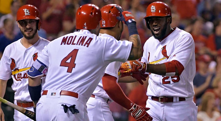 St. Louis Cardinals center fielder Dexter Fowler (25) celebrates with left fielder Tommy Pham (28) and catcher Yadier Molina (4) after hitting a grand slam St. Louis Cardinals center fielder Dexter Fowler (25) celebrates with left fielder Tommy Pham (28) and catcher Yadier Molina (4) after hitting a grand slam