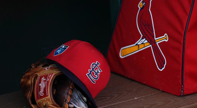 St. Louis Cardinals gear sits in the dugout. St. Louis Cardinals gear sits in the dugout.