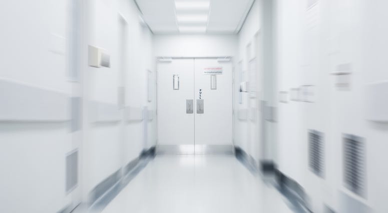 Empty corridor in modern hospital. Empty long hallway in the hospital. Empty clinic hall with white walls.