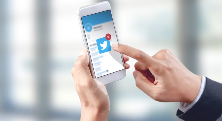 twitter, smartphone Businessman hand touch twitter icon on mobile screen, social media