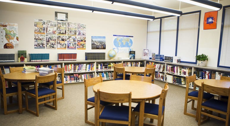 school library Tables and chairs with book shelves arranged in high school library