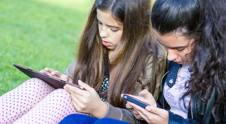 social media, kids Young girls having fun posting on social media