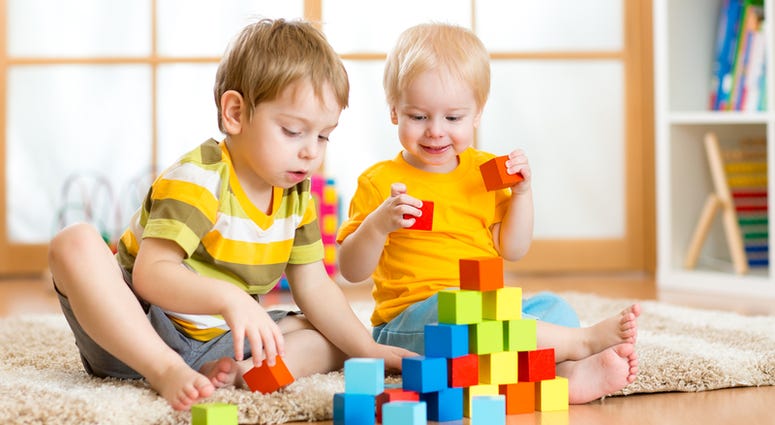 kids playing Kids playing block toys in playroom at nursery