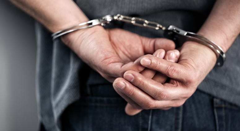handcuffs Arrested man in handcuffs with hands behind back