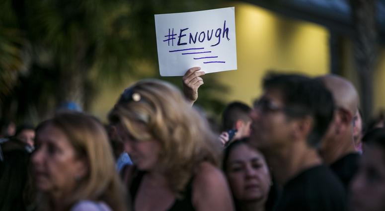 Feb. 15, 2018; Parkland, FL, USA; People mourn during a candlelight vigil after a shooting at Marjory Stoneman Douglas High School on Wednesday that took 17 lives. Credit: Dorothy Edwards/Naples Daily News via USA TODAY NETWORK Feb. 15, 2018; Parkland, FL, USA; People mourn during a candlelight vigil after a shooting at Marjory Stoneman Douglas High School on Wednesday that took 17 lives. Credit: Dorothy Edwards/Naples Daily News via USA TODAY NETWORK