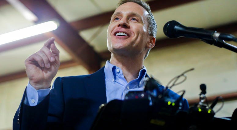 Missouri Gov. Eric Greitens cheers on a crowd after several protestors were removed from the building before a ceremonial signing making Missouri a "right-to-work" state Missouri Gov. Eric Greitens cheers on a crowd after several protestors were removed from the building before a ceremonial signing making Missouri a "right-to-work" state