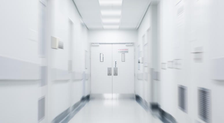 Empty corridor in modern hospital. Empty long hallway in the hospital. Empty clinic hall with white walls.