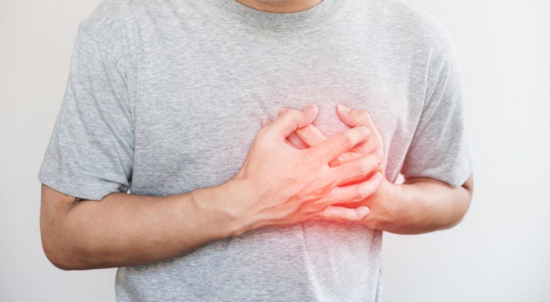 heart attack A man touching his heart, with red highlight of heart attack, and others heart disease concept, on white backgrounds
