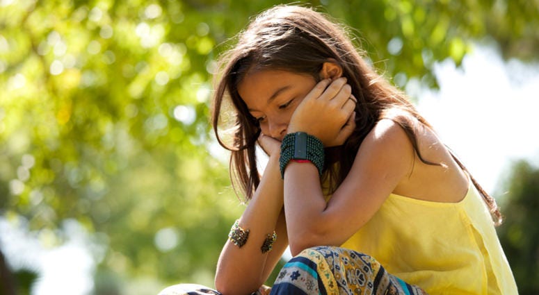 depression Young child at the park with a depression
