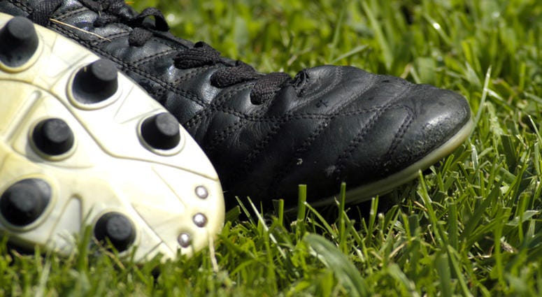 Soccer or football cleats in grass