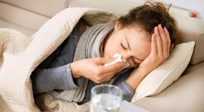 Sick Woman. Flu. Woman Caught Cold. Sneezing into Tissue