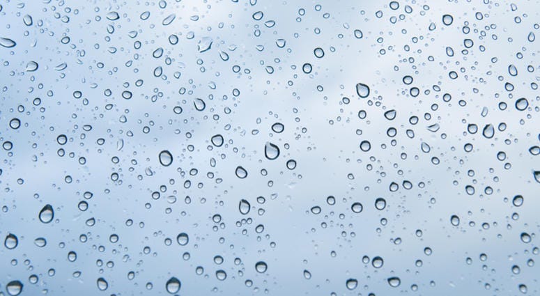 Rain water drops texture on a blue glass surface