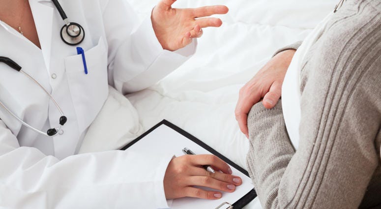 doctor, patient Doctor and sick patient lying in bed