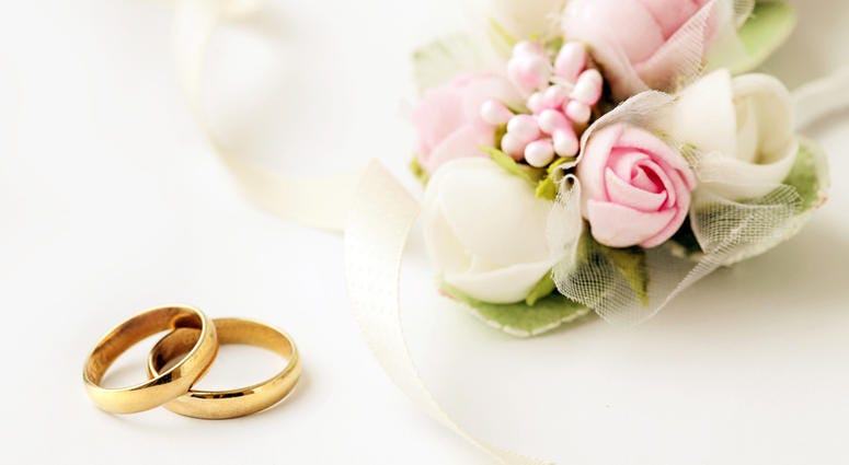 wedding Two golden wedding rings and flowers