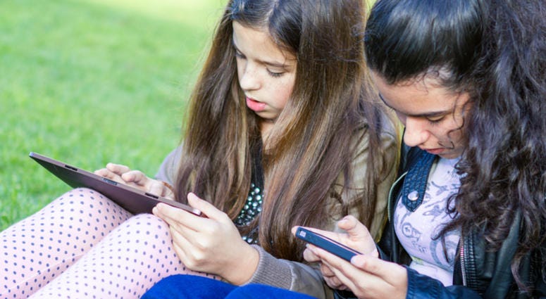 social media, kids Young girls having fun posting on social media