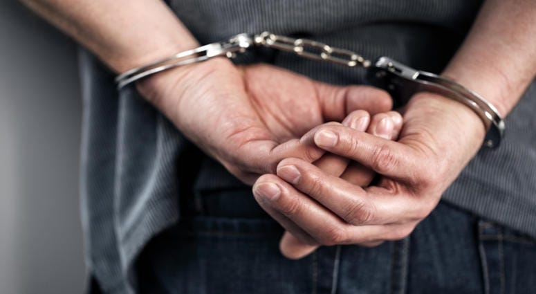 handcuffs Arrested man in handcuffs with hands behind back