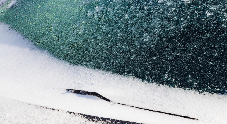 Ice and snow covers windshield and Windscreen wiper after snow storm