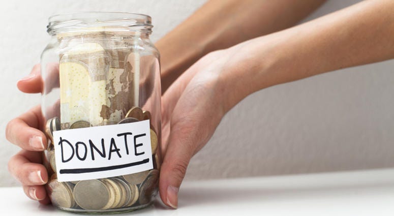 Donation, fund raiser Donate note on a money jar donation concept