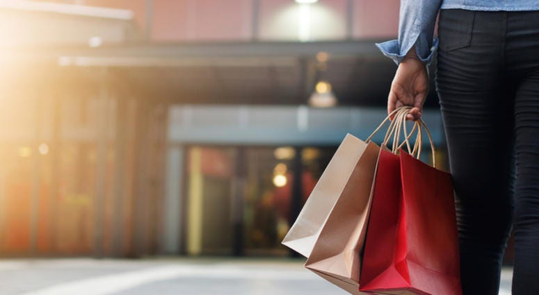 mall, shopping Woman walking with shopping bags on shopping mall background.