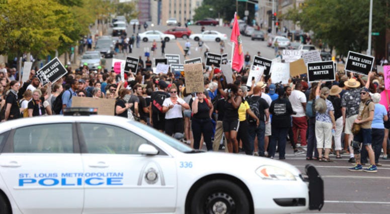 Police block the streets for protesters during a peaceful protest outside of St. Louis Metropolitian Police Headquarters in St. Louis on September 17, 2017.