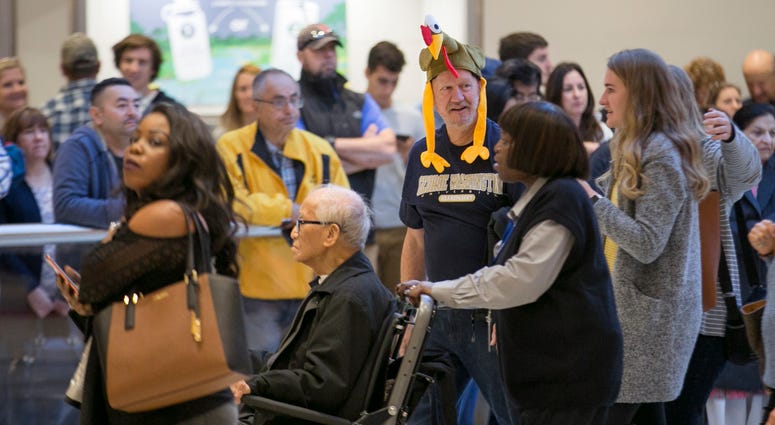 Arriving passengers head toward the baggage claim area at Hartsfield-Jackson Atlanta International airport on Wednesday, Nov. 22, 2017.
