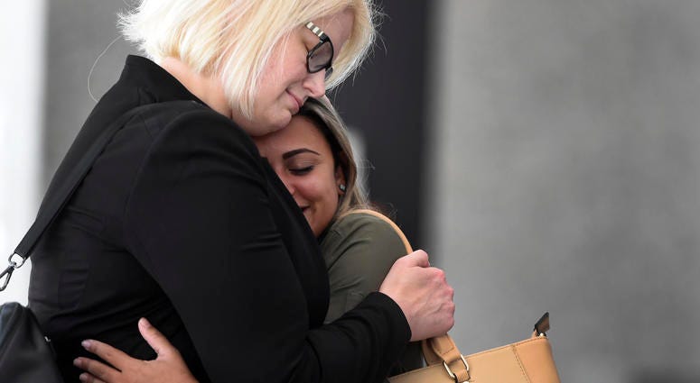 Sirley Silveira Paixao, right, an immigrant from Brazil seeking asylum, hugs her Chicago based attorney Britt Miller, after a hearing where a federal judge ordered the release of her 10-year-old son Diego from immigration detention, Thursday, July 5, 2018