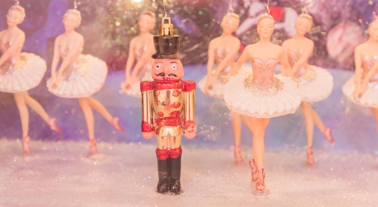 Christmas nutcracker toy soldier and balerina dolls on the stage. Famous Russian Ballet installation.