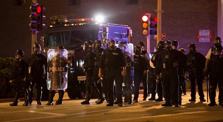 Police officers stand guard in St. Louis, Missouri, the United States, Sept. 17, 2017. Protesters smashed windows and other property in downtown St. Louis, Missouri Sunday night.