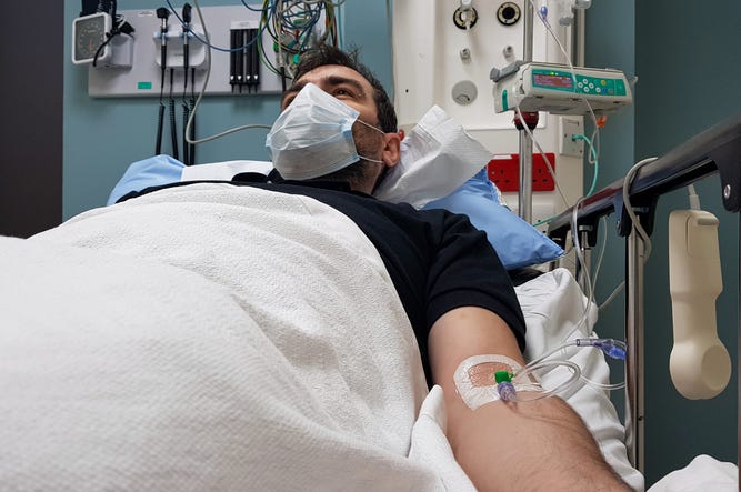 Dreamer De Dallas Con Cáncer Podría Ser Deportado Young man lying in hospital bed. Recovering in modern hospital wards, covered with blanket, face mask and with intravenous needle in his arm