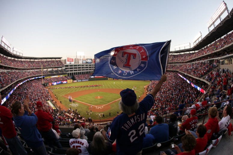 Familia Hispana Sufre Racismo En Partido De Los Rangers A fan waves a flag during Game Four of the MLB World Series between the St. Louis Cardinals and the Texas Rangers at Rangers Ballpark in Arlington on October 23, 2011 in Arlington, Texas.