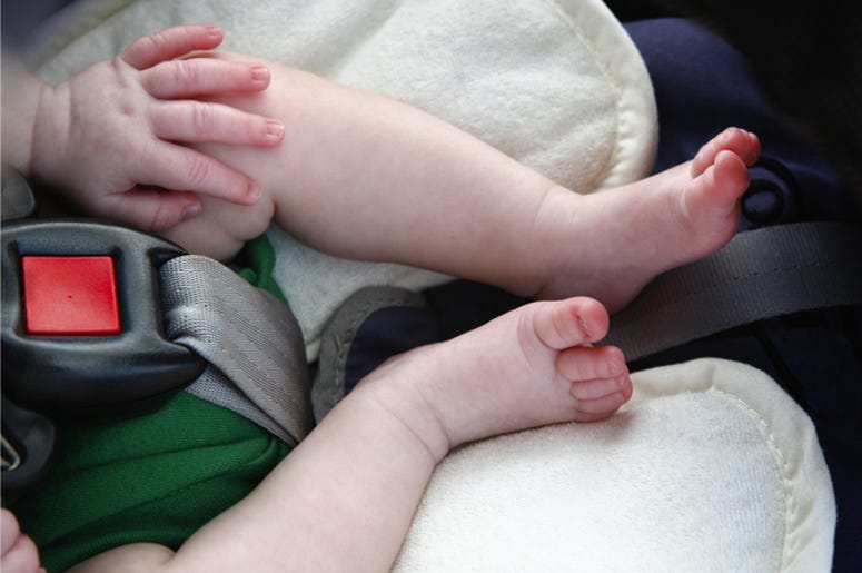 Niña Muere En Auto Caliente Mientras Su Madre Se Emborrachaba Legs and hand of little child in car seat.