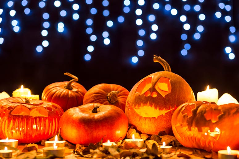 El Festival Pumpkin Nights Llega A Dallas Este Otoño Cropped shot of carved pumpkins amongst the leaves standing on a table