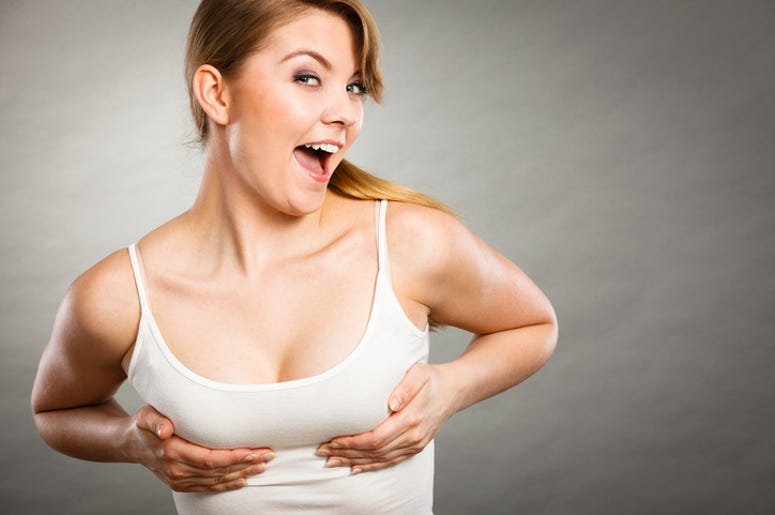 El Baile De La Chichi De Los Médicos Y Enfermeras Del IMSS Health care, bosom concept. Young happy joyful woman wearing tshirt holding hands on breast and pushing them up